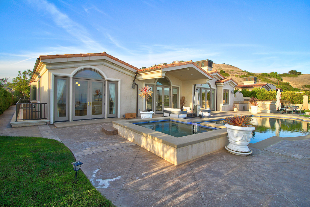 a home with a pool and patio area
